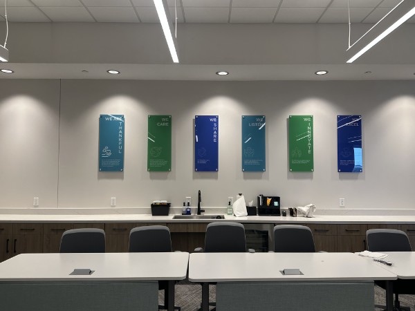 Interior conference room with a row of dimensional wall panels, installed by E&A Signs