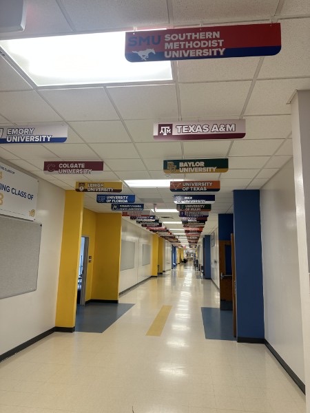 Interior school hallway with college-name banners hung from the ceiling, installed by E&A Signs