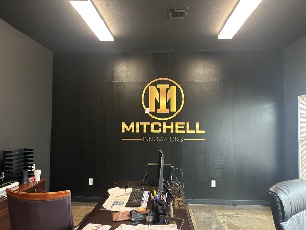 Interior office with a dimensional Mitchell Innovations logo on the wall, installed by E&A Signs