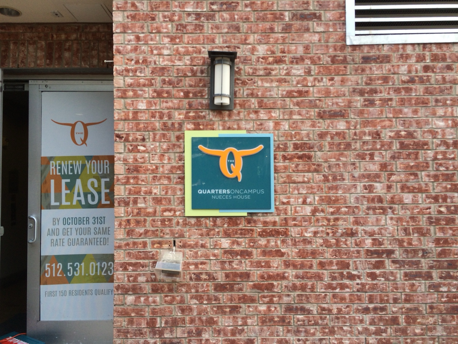 Exterior wall-mounted sign and window graphics, installed by E&A Signs