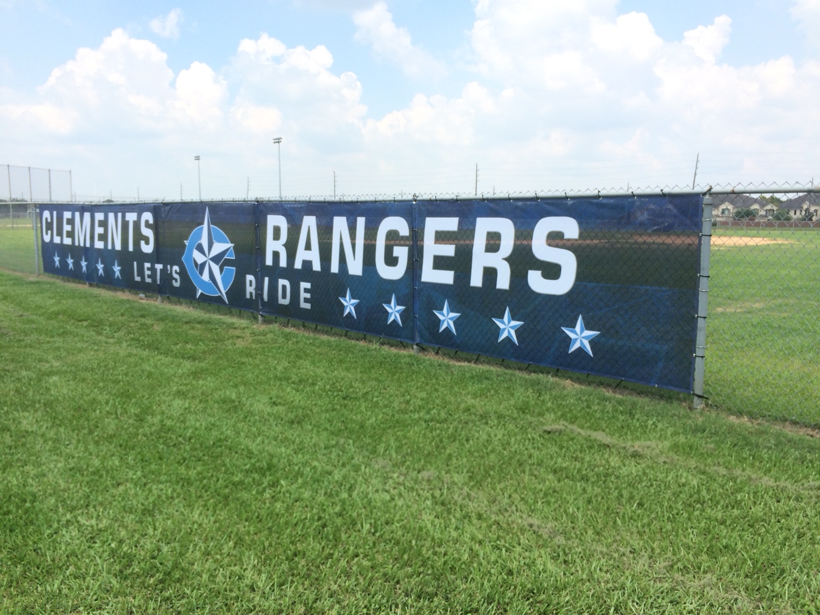 Exterior mesh fence banner reading Clements Rangers, installed by E&A Signs