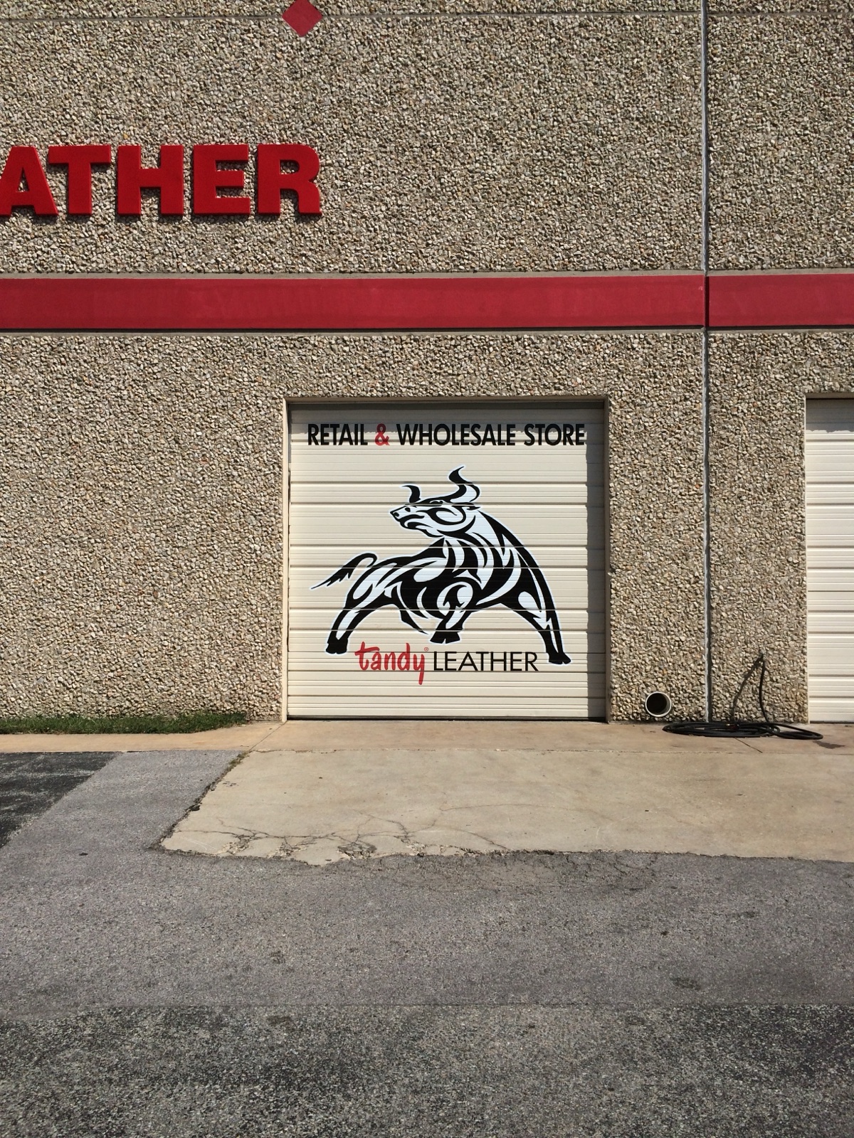 Exterior channel letters and roll-up door graphics for dandy Leather, installed by E&A Signs