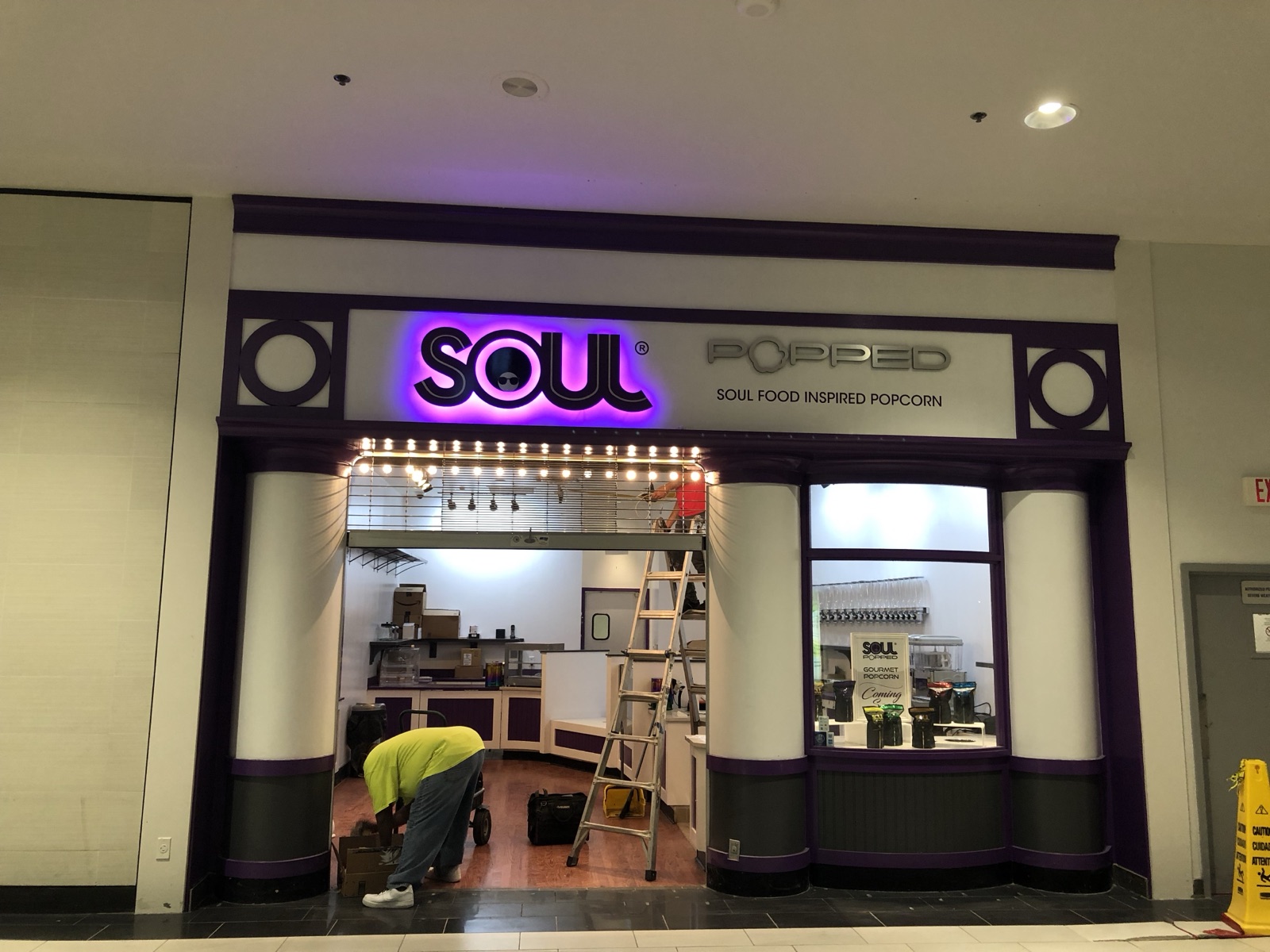 Illuminated channel-letter storefront sign in a mall, installed by E&A Signs